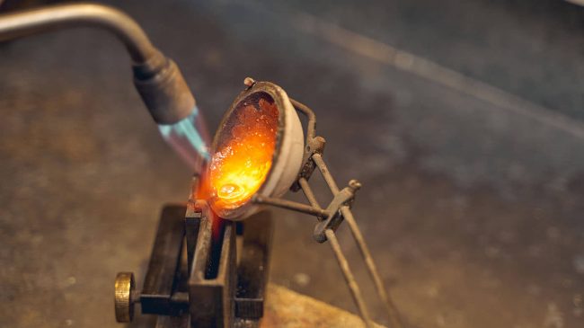 goldsmith-using-a-blowtorch-for-the-metalwork-2021-09-03-14-17-35-utc